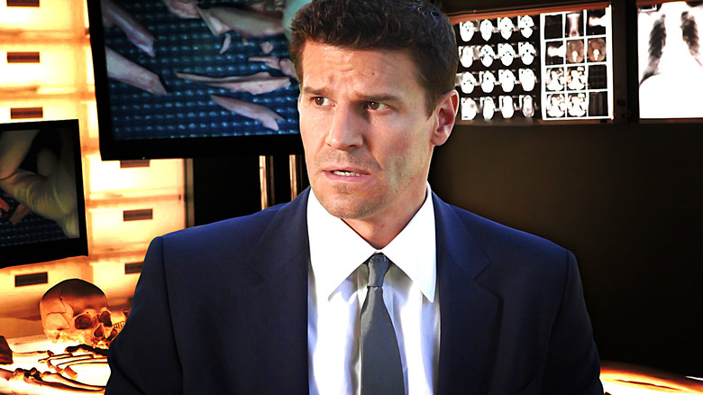 Booth looking scared in a suit with a lab background on Bones
