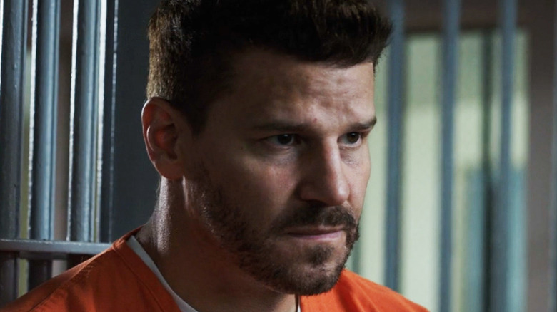 David Boreanaz's Agent Seeley Booth sits looking concerned in prison in Bones