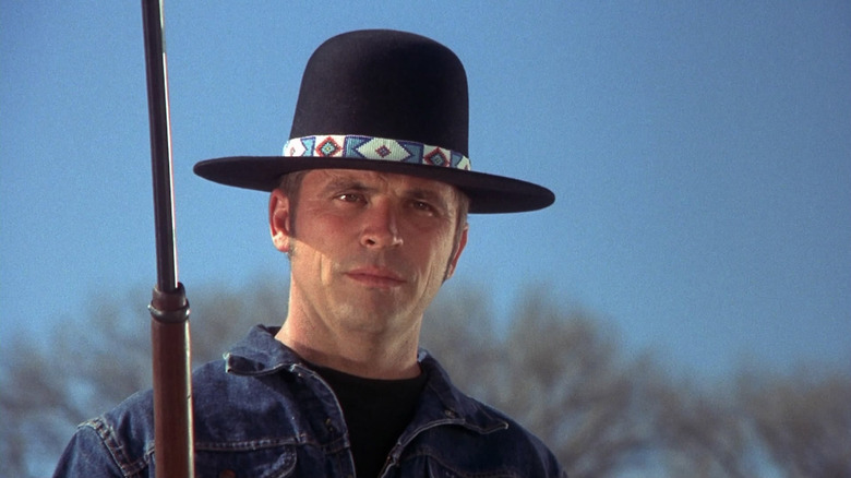 Tom Laughlin as Billy Jack holding up his rifle in Billy Jack
