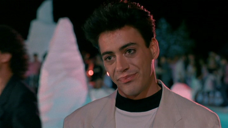 Robert Downey Jr. as Julian Wells smiles emptily in Less Than Zero