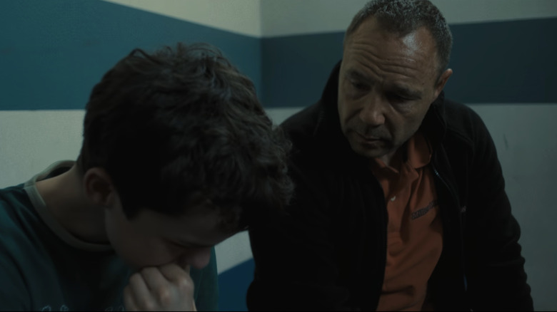 Owen Cooper's Jamie Miller holds his head in his hands as Stephen Graham's Eddie Miller watches in Adolescence