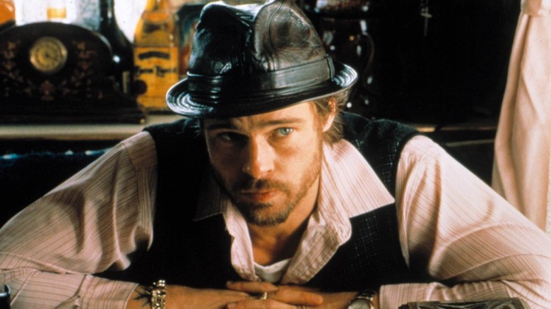 Brad Pitt as Mickey in Snatch leaning forward on a table