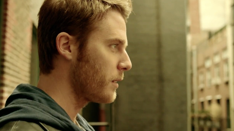 Jake McDorman as Brian Finch staring into the distance in the Limitless TV show