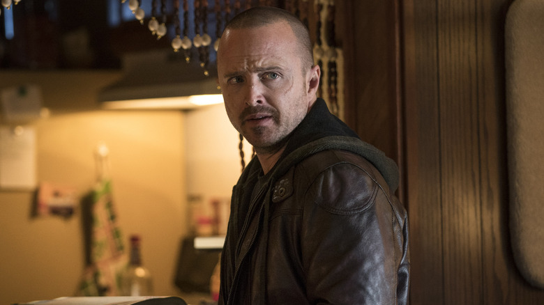 Aaron Paul as Jesse Pinkman with a phone in his hand and a nervous look on his face in El Camino: A Breaking Bad Movie