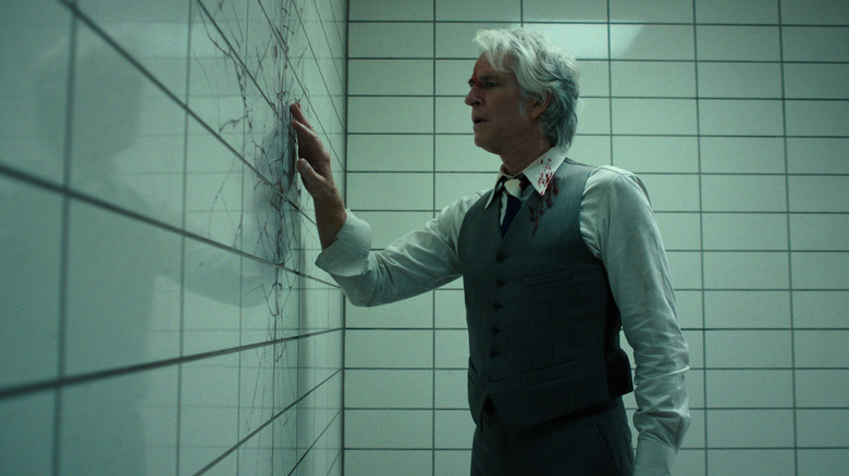 Dr. Brenner examining a crack in a wall in Stranger Things