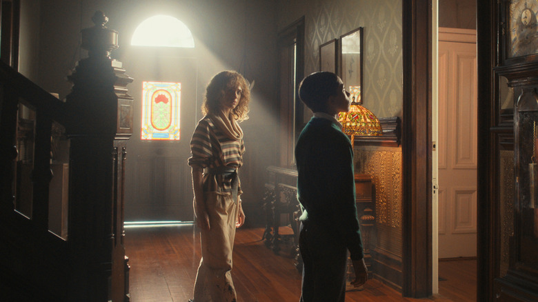 Young Henry Creel standing in the Creel House in Stranger Things