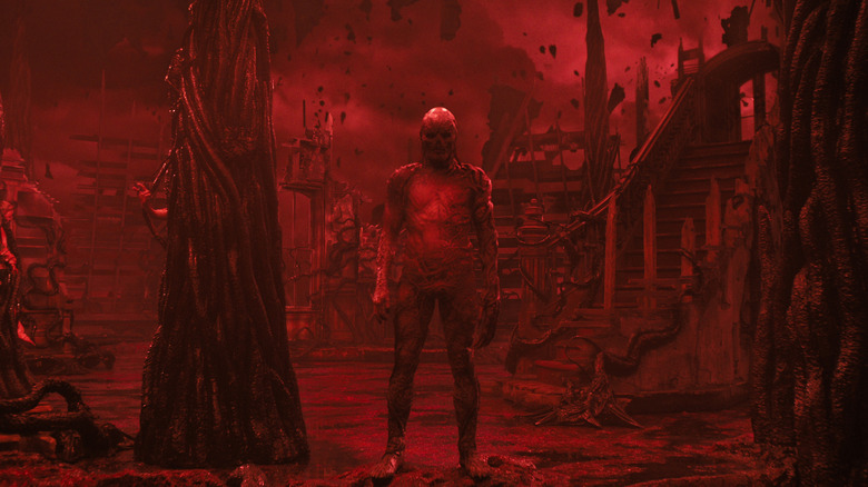 Vecna standing in the red glow of the Upside Down in Stranger Things