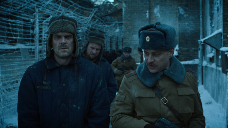Hopper being escorted through a Russian prison in Stranger Things