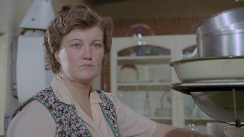 Brenda Fricker as Bridget Fagan Brown standing in a kitchen with an emotional look on her face in My Left Foot