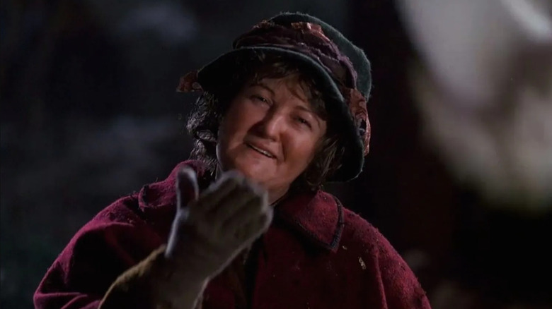 Brenda Fricker as Pigeon Lady wearing winter clothes and smiling in Home Alone 2: Lost in New York
