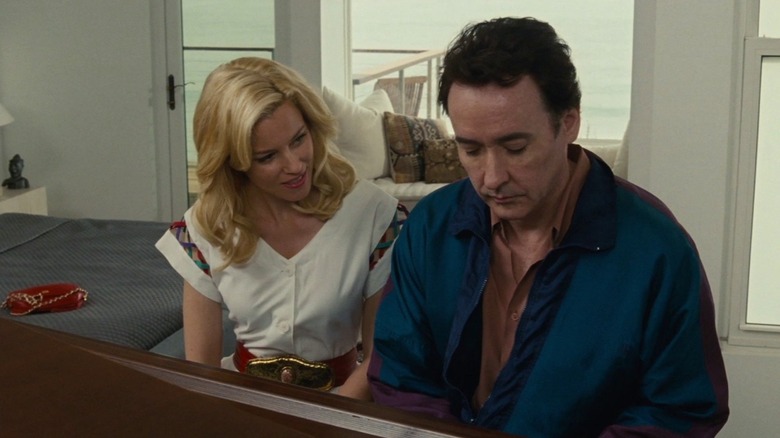 John Cusack as Brian Wilson sits at a piano with Elizabeth Banks as Melinda Ledbetter in Love & Mercy