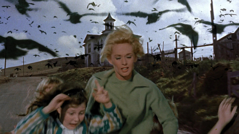 Melanie and two children running away from a flock of killer birds in The Birds