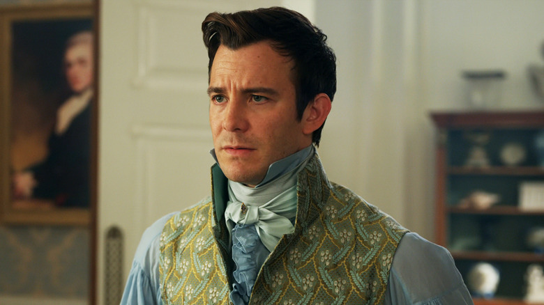Luke Thompson's Benedict Bridgerton looks worried as he stands in a room in Bridgerton