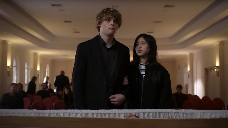 Andy and Piper stand in front of the coffin containing their dead father in Bring Her Back