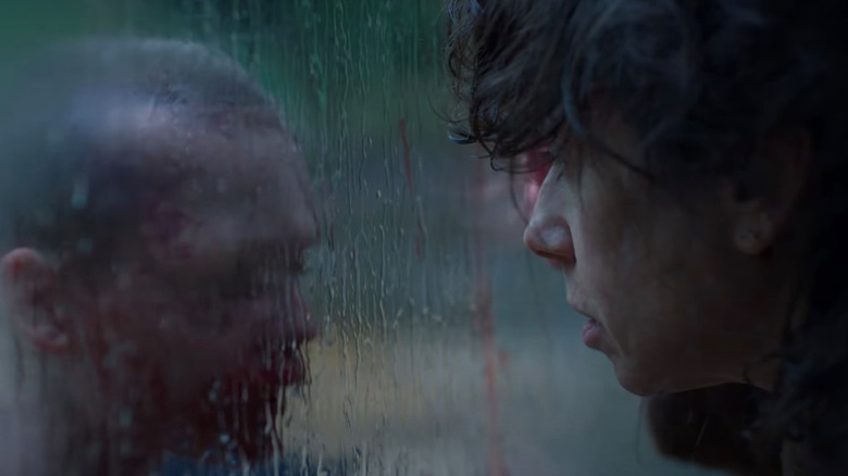 Laura looks through a rain-soaked window and sees Oliver in Bring Her Back
