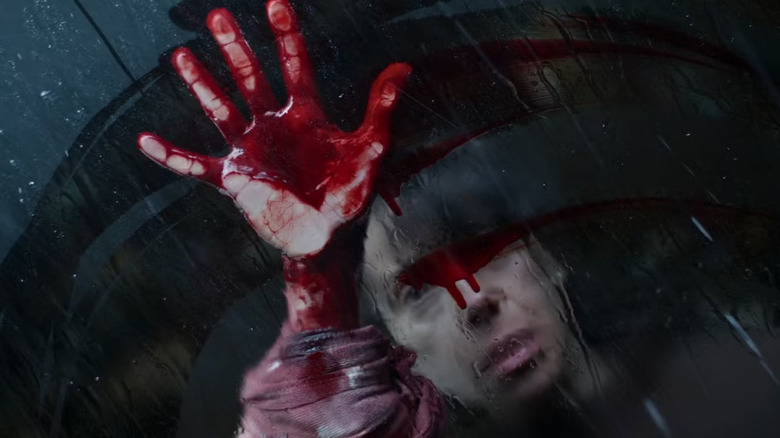 Laura smearing blood on a window in Bring Her Back
