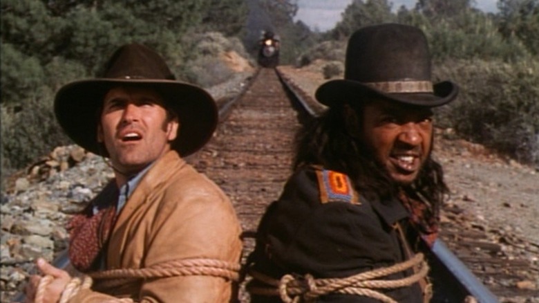 Brisco County, Jr. and Lord Bowler tied to rail tracks on "The Adventures of Brisco County, Jr."