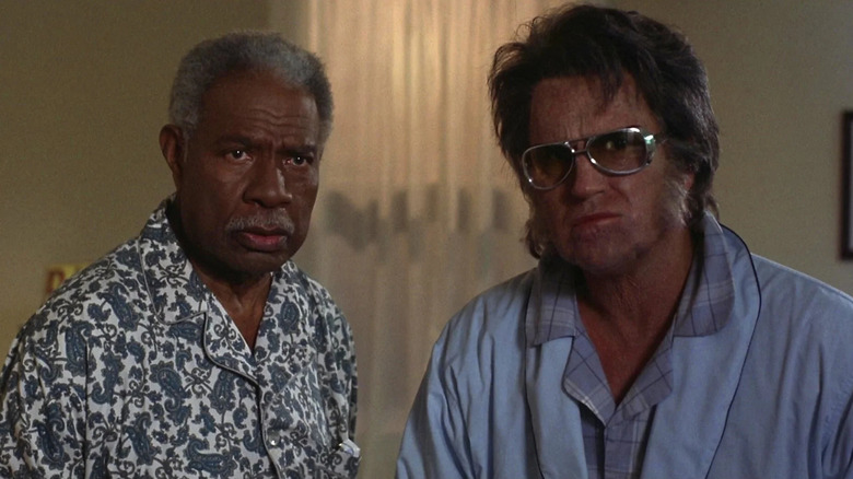 Ossie Davis as John F. "Jack" Kennedy and Bruce Campbell as Elvis Presley sitting together in Bubba Ho-Tep