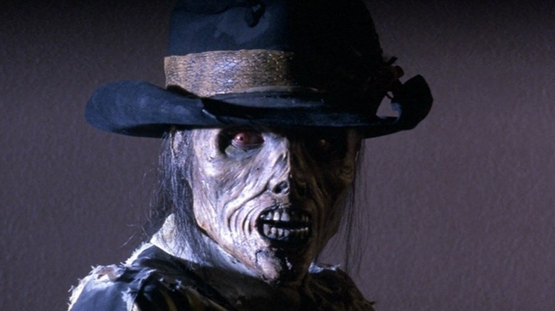 A close up of Bubba-Hot Tep standing against a plain white wall in Bubba Ho-Tep