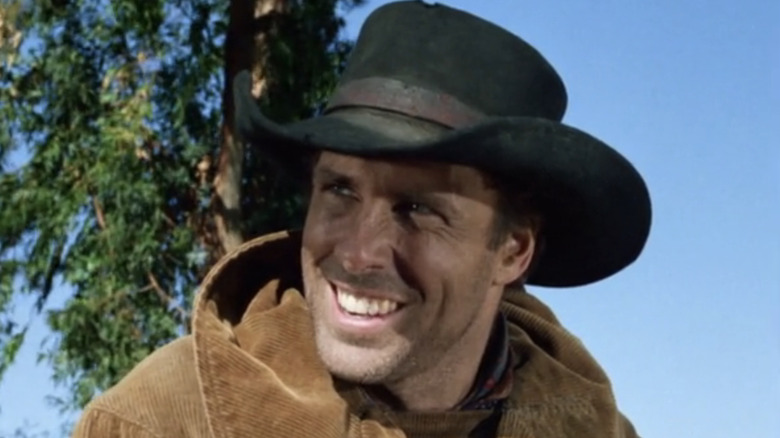 Bruce Dern as Guerin smiles against a blue sky in Gunsmoke
