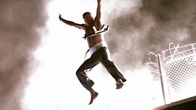 John McClane hangs from the side of Nakatomi Plaza in Die Hard