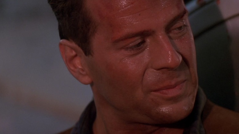 Bruce Willis's John McClane sweats as he looks right at 