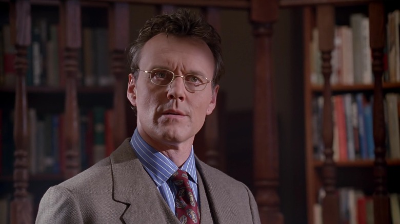 Anthony Stewart Head as Giles on Buffy the Vampire Slayer, standing in the library