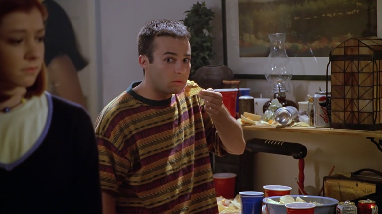Danny Strong as Jonathan on Buffy the Vampire Slayer, pausing before taking a bite of chip and dip