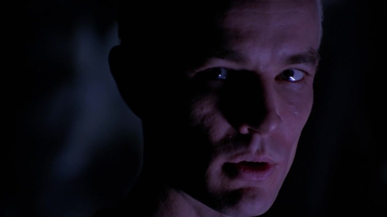 A closeup of James Marsters as Spike on Buffy the Vampire Slayer, lit purple