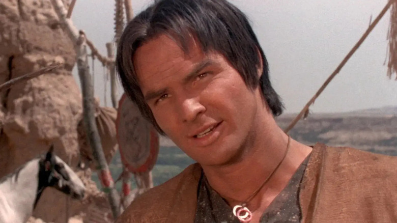 Navajo Joe stands with his head to one side in Navago Joe