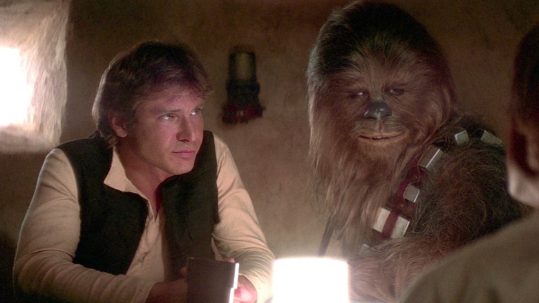 Han Solo and Chewbacca sitting at a table in Star Wars: A New Hope