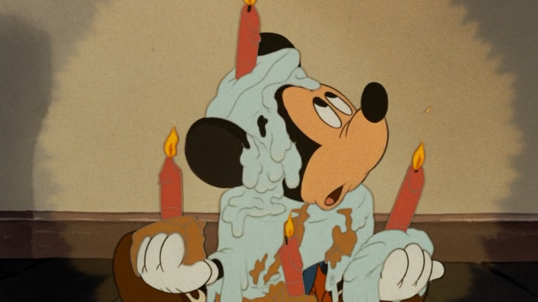 Mickey holding melted candles in Mickey's Birthday Party
