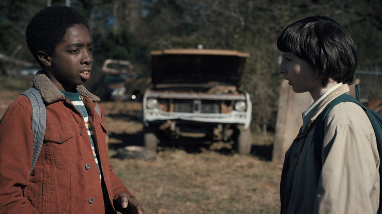 Caleb McLaughlin's Lucas Sinclair stands opposite Finn Wolfhard's Mike Wheeler outside in Stranger Things