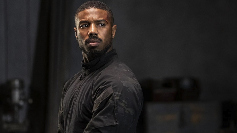 Michael B. Jordan as John Kelly standing in a storage room in Without Remorse