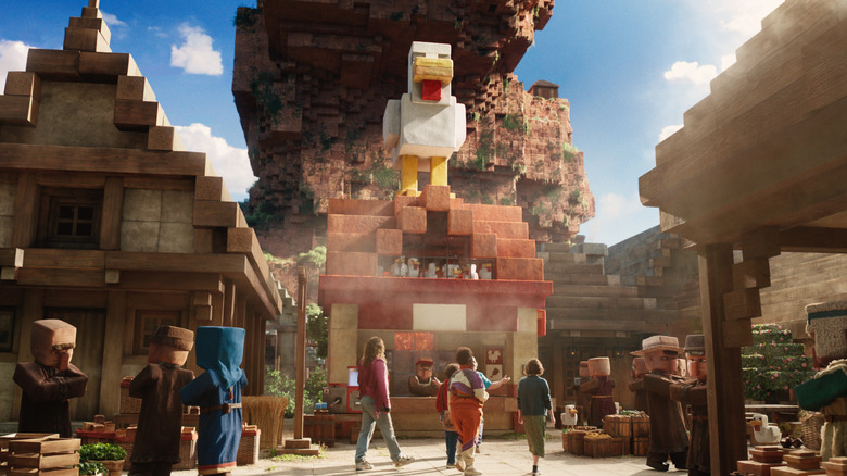 Garrett, Henry, Natalie, and Dawn walking by the chicken building in A Minecraft Movie