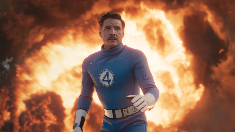 Pedro Pascal as Reed Richards standing in front of flames in The Fantastic Four: First Steps