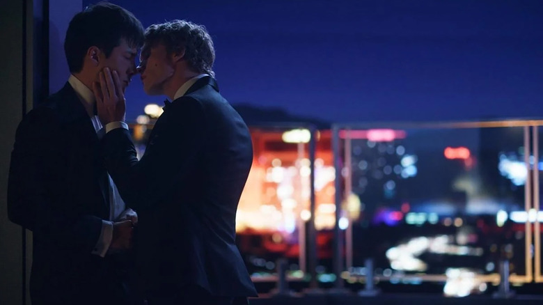 Shane and Ilya stealing a kiss on the balcony in Heated Rivalry