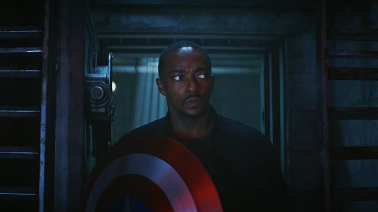 Anthony Mackie's Sam Wilson holding his shield walking into The Leader's lair in Captain America: Brave New World