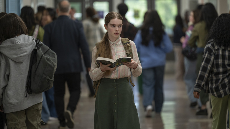 Carrie (2026) - Carrie White walking in school hall reading book
