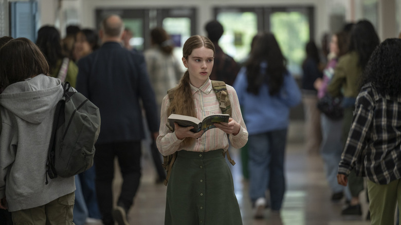 Carrie holds a book in the school hallway in Carrie (2026)