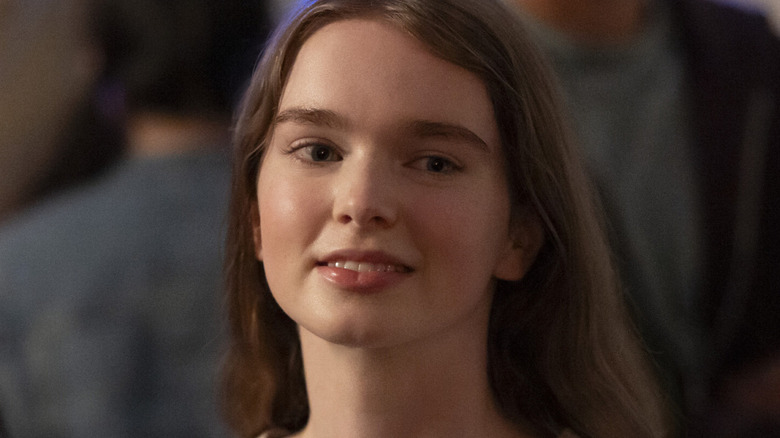 Carrie (Summer H. Howell) smiles awkwardly at a party