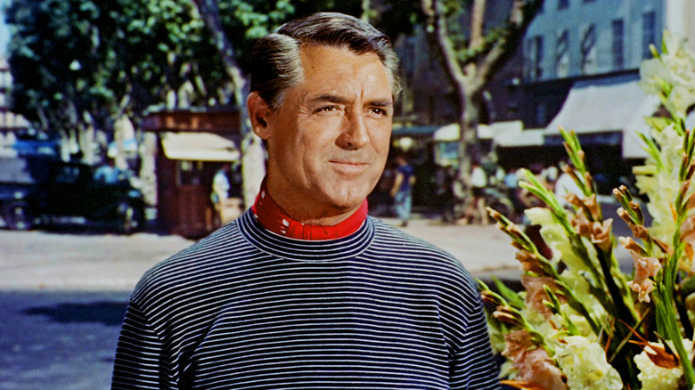 Cary Grant's John Robie stands in a flower market in To Catch a Thief