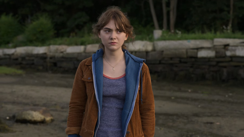 woman looking to her left in a jacket and hoodie