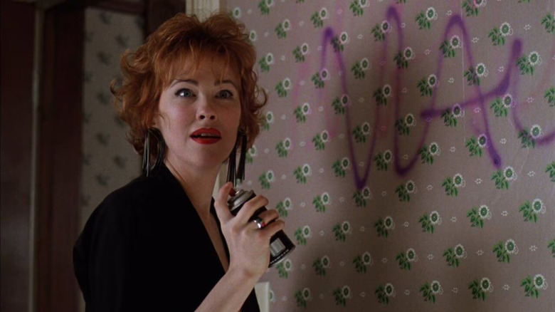 Catherine O'Hara as Delia Deetz spray-painting a wall in Beetlejuice