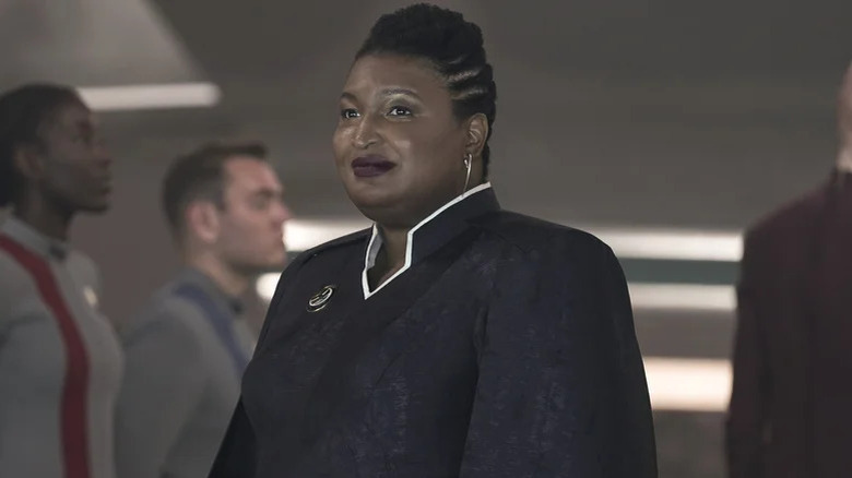 The President of Earth (Stacey Abrams) smiles amid a Starfleet delegation in Star Trek: Discovery