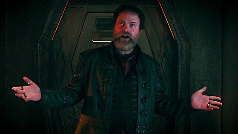 Harry Mudd (Rainn Wilson) looks up raising his hands in Star Trek: Discovery