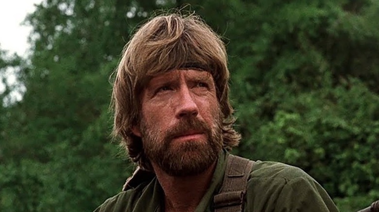 James Braddock (Chuck Norris) standing in front of some trees in "Missing In Action"