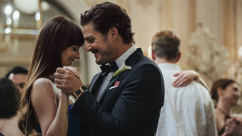 Lucy and Harry smile as they slow dance in Materialists