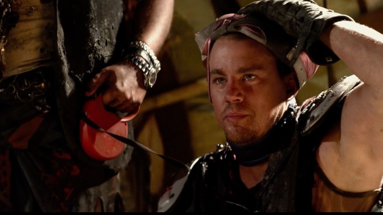 Channing Tatum as himself wearing a dog collar and lifting up a gimp mask in This is the End