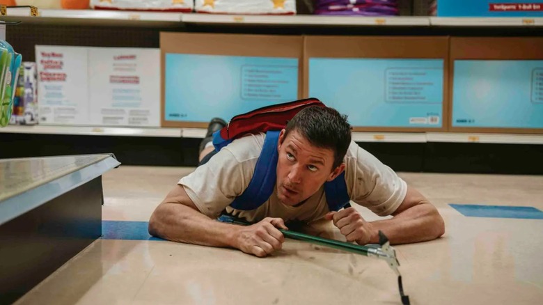 Jeffrey army crawling through a store in Roofman